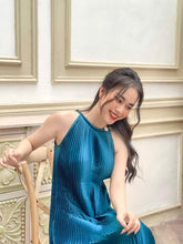 Pleated silk midi dress with halter neckline and soft flowing A-line silhouette